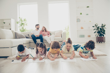 Portrait of friendly lovely brothers and sisters drawing togethe
