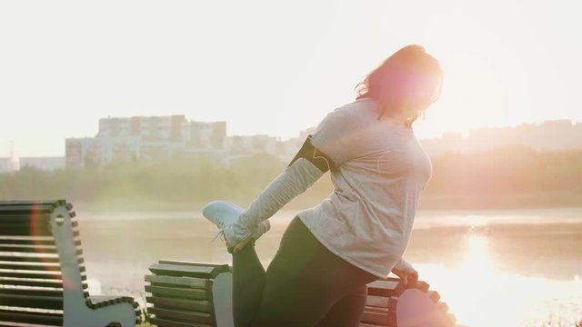 Woman stretching her legs before running 