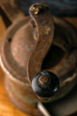 macro photo of rust and various parts of the old coffee grinder