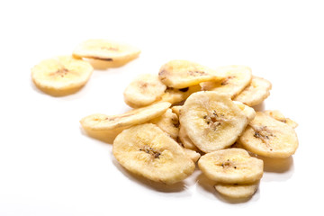 Close-up of dried banana slices on white background..