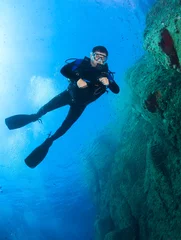 Foto auf Acrylglas Scuba diver underwater in the deep blue ocean and backlight sun. © frantisek hojdysz