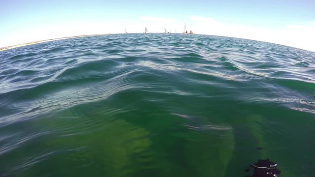 A diver above the water, watching and shooting competitions regatta yachts. Portugal Algarve