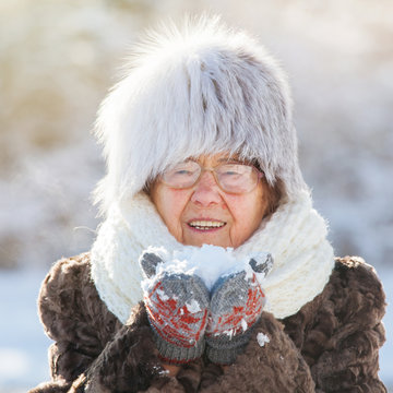 Old woman walking at winter park