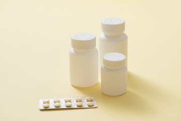 Bottles of medicines and pills in a blister pack.