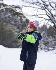 Fototapeta na wymiar young boy about to throw a snowball
