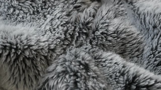 Warming artificial fur fabrics details 4K panning footage