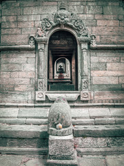 Close up of one window in old stone sacred building, inline with other windows in the background....