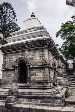 Close up of one old stone sacred building, inline with other behind. Pashupatinath Temple in Kathmandu, Nepal.