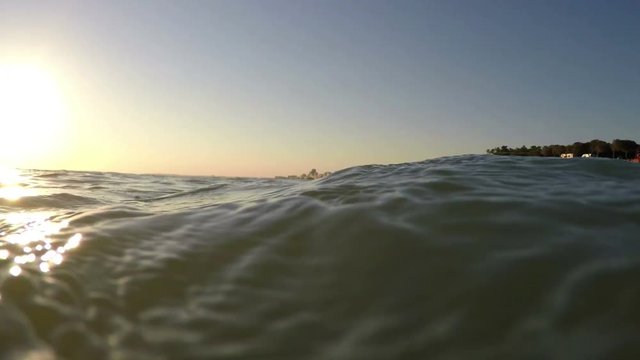Shooting from sea, sunset and waves cover camera. Portugal Algarve.