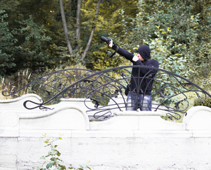 man with a camera in autumn park