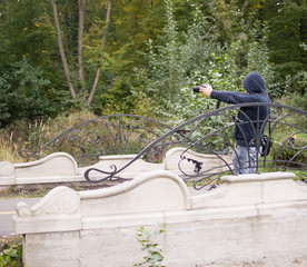 man with a camera in autumn park