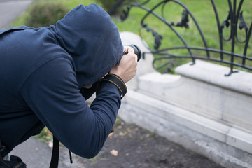 man with a camera in autumn park
