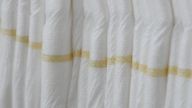 Row of nappies from brand new package 4K panning footage