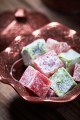 Turkish delight (lokum) in traditional oriental carved patterned metal plate