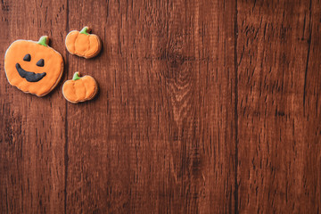 Fresh delicious homemade decorated halloween cookies sweets on dark wooden background, concept of halloween party, copy space(text space), top view, blank for text.