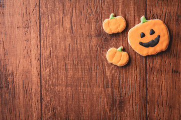 Fresh delicious homemade decorated halloween cookies sweets on dark wooden background, concept of halloween party, copy space(text space), top view, blank for text.