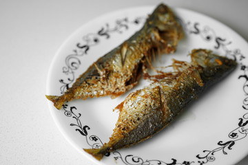 deep fried trevally fish on white plate