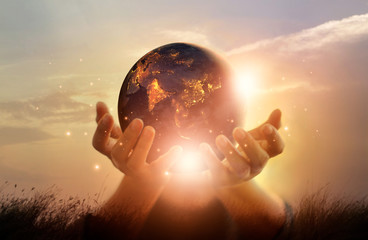 Earth at night was holding in human hands. Earth day. Energy saving concept, Elements of this image...