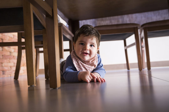 beautiful baby boy under the table