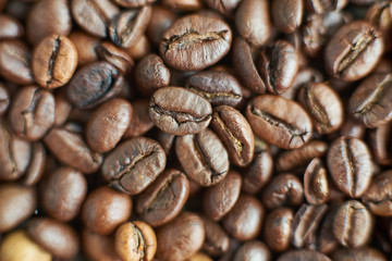 Roasted coffee beans on rustic wooden background. Food ingredients, top view, space for text
