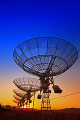 The silhouette of a radio telescope observatory