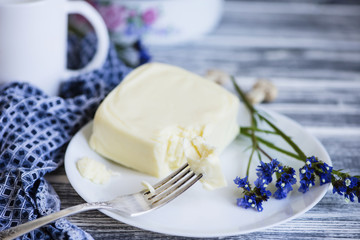 mozzarella cheese on a plate on a wooden background