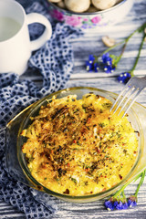 baked mashed potatoes with sausages and cheese in a plate