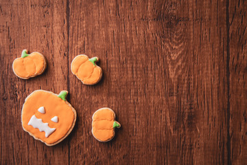 Fresh delicious homemade decorated halloween cookies sweets on dark wooden background, concept of halloween party, copy space(text space), top view, blank for text.