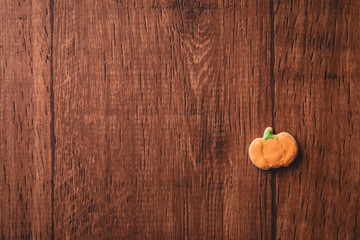 Fresh delicious homemade decorated halloween cookies sweets on dark wooden background, concept of halloween party, copy space(text space), top view, blank for text.