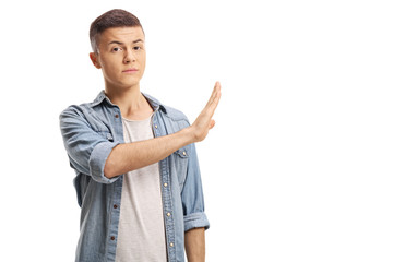 Young male gesturing stop with his hand