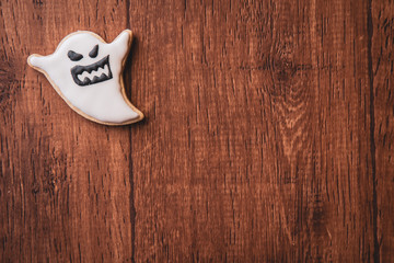 Fresh delicious homemade decorated halloween cookies sweets on dark wooden background, concept of halloween party, copy space(text space), top view, blank for text.