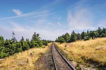 Obraz premium Prairie landscape with a railroad under a blue sky