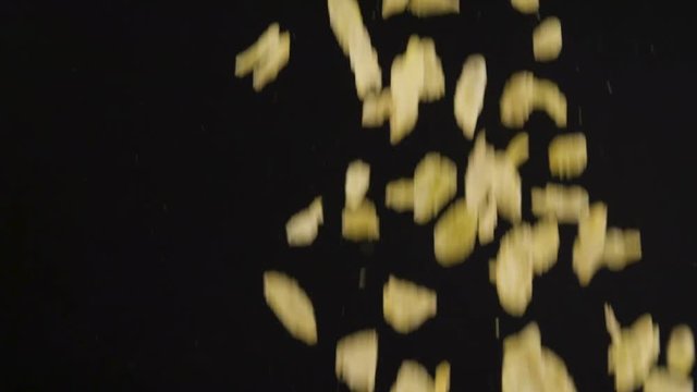 Corn flakes falling into bowl