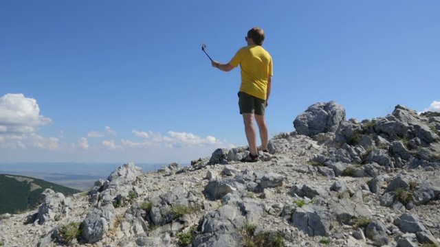 Young man making selfie on mountain