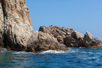 sea water splashing rocky coastline on the shores of Tossa De Mar