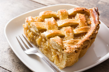 Homemade apple pie slice on wooden table