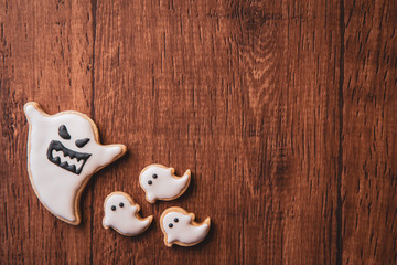 Fresh delicious homemade decorated halloween cookies sweets on dark wooden background, concept of halloween party, copy space(text space), top view, blank for text.
