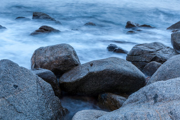 Rocks and surf, waves hitting the shores and beach coastline