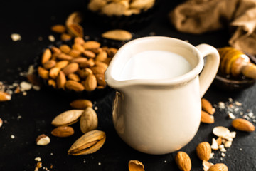 Homemade almond milk in jug. Almond milk and almonds