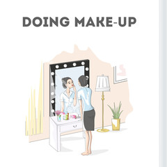 Woman doing make up at the mirror