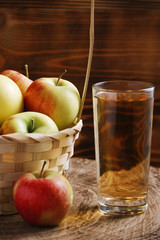 Apple cider in glass on wood background
