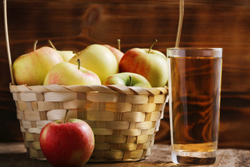 Apple cider in glass on wood background