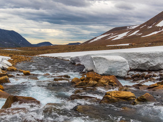 Beautiful mountain landscape, panorama. Snowy peak. Mountain river. Polar urals mountains. Yamal