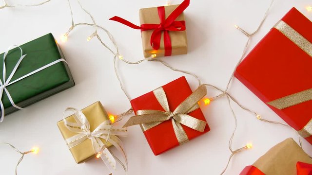 christmas and holidays concept - wrapped gifts set and garland string on white background