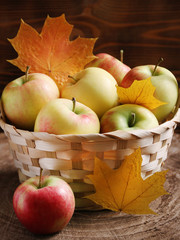 basket full of apple and autumn leaves