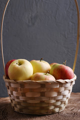 apple in basket on background wood and dark low key