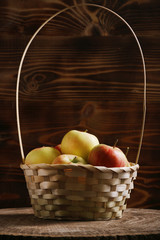 apple in basket on wood background