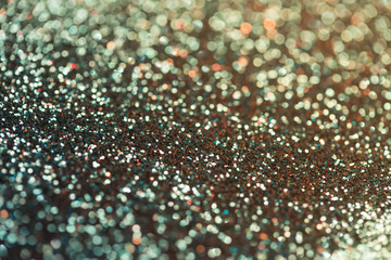 festive multicolor and blue glitters background with bokeh and light leak effect