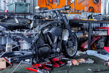 Cropped close up shot of beautiful and custom made motorcycle in the workshop