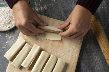 man preparing meat stuffed cannelloni